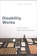 Disability Works Symmetrically organized items on a desk in front of a white wall.