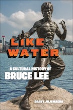 Like Water Statue of Bruce Lee stands in front of a body of water.